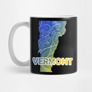 Colorful mandala art map of Vermont with text in blue and yellow Mug